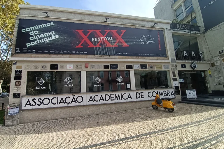 The student union building on Praça da República, with Associação Académica de Coimbra lettered in tiles along its front.