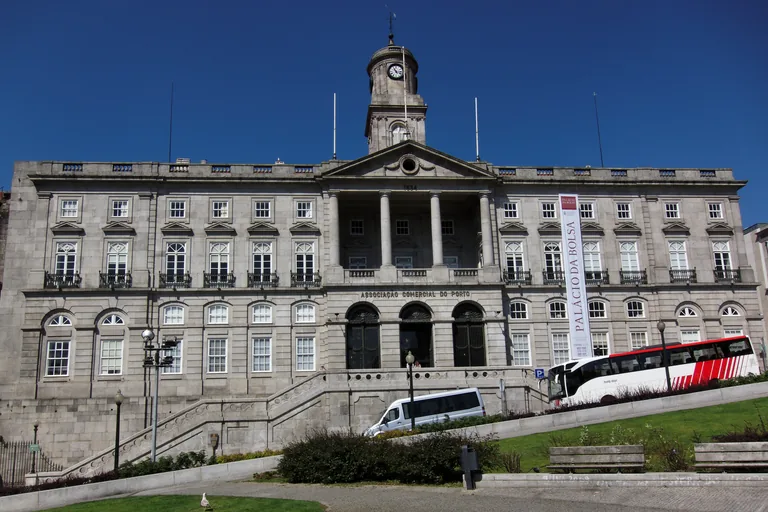 The granite front of the Palácio da Bolsa with its columned portico and clock tower.