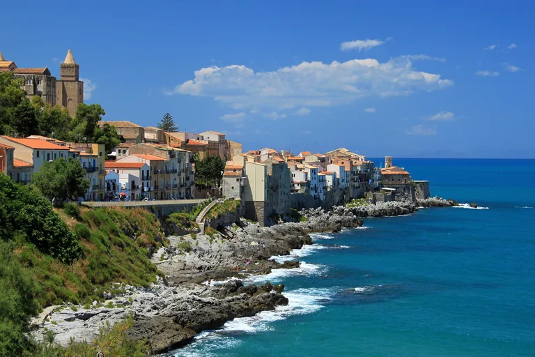 Cefalu's historic waterfront and rocky shore viewed from the east.
