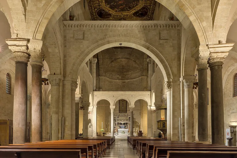 The stone nave and arches inside Bari's Basilica of San Nicola.