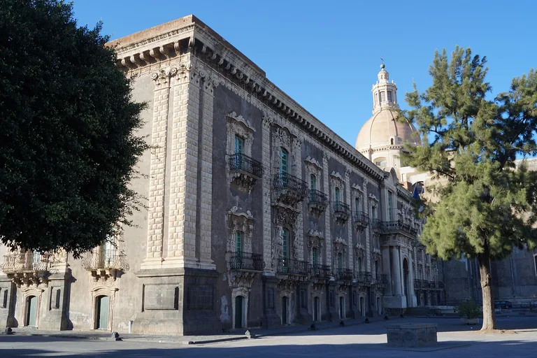 The long east facade and dome of Catania's Benedictine Monastery.