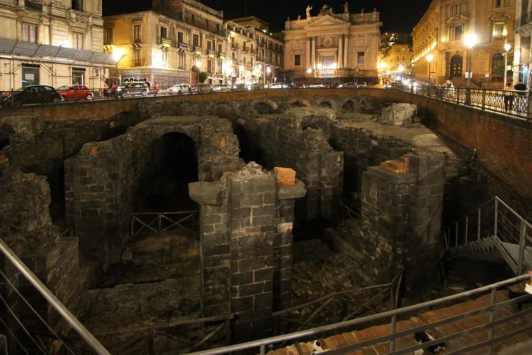 The excavated Roman amphitheatre in Piazza Stesicoro at night.