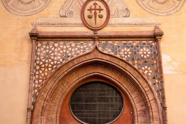 The Church of Santiago's brick-and-tile Mudéjar entrance on Calle Granada