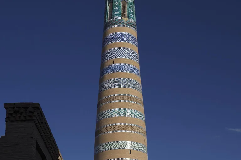 The Islam Khodja minaret — 1910, the tallest structure in the old city, tapering to its lantern