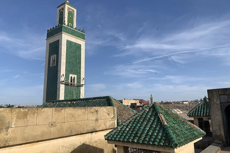 The Great Mosque's minaret and green-tiled roofs, seen from Bou Inania Madrasa