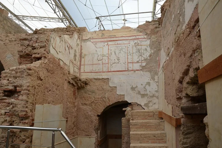 Inside Terrace House 2 under its protective roof, frescoed walls exposed