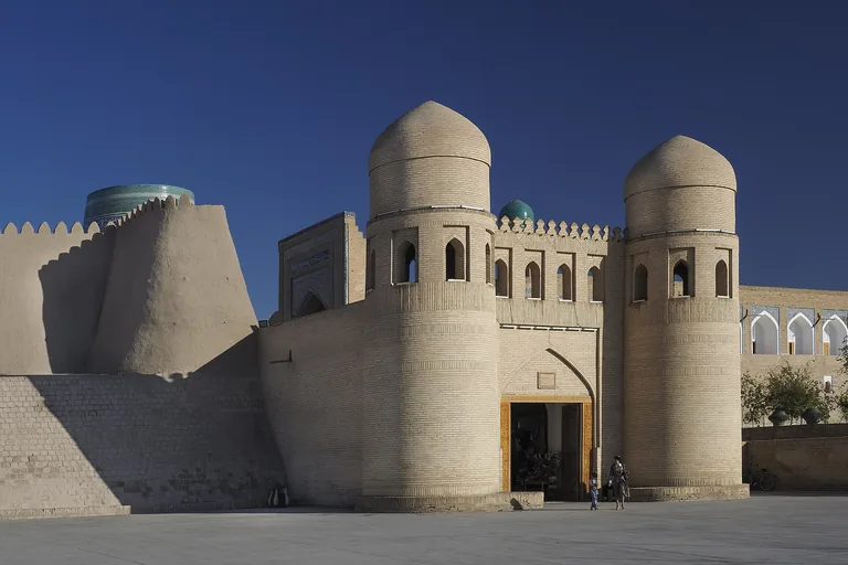 Ota Darvoza, the west gate, with the sloping mud-brick wall of the Kunya-Ark behind
