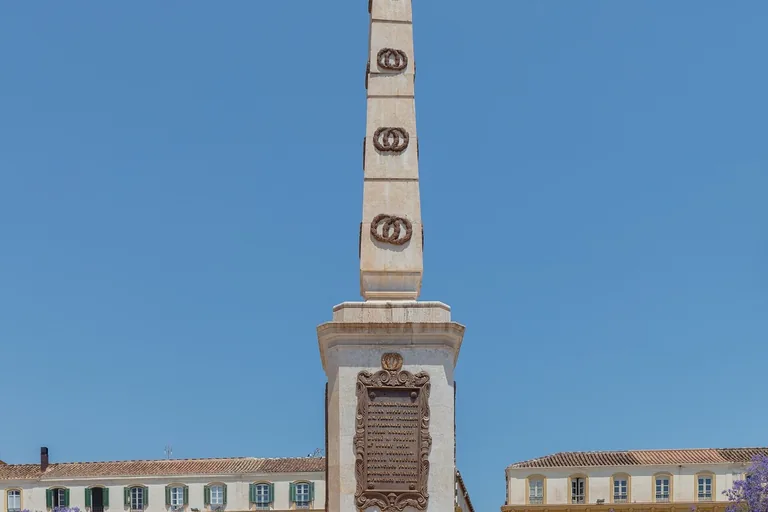 The Torrijos monument and its fenced crypt at the centre of Plaza de la Merced