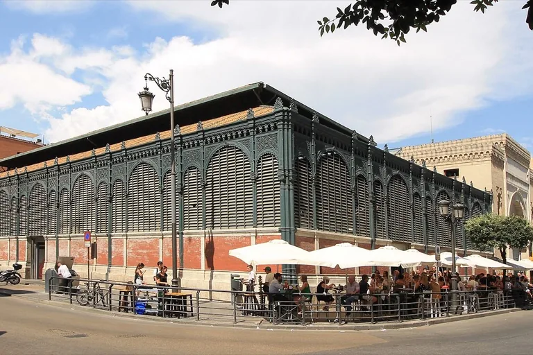 Atarazanas Market's iron hall with the reused monumental gate visible at the east end