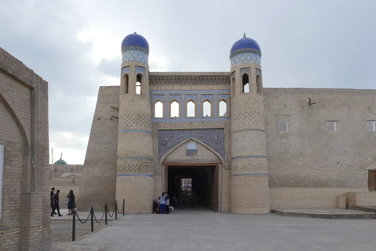 Polvon Darvoza from outside the walls — the east gate, with its twin blue-domed towers