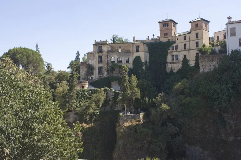 The house and its terraced garden on the lip of the gorge; the mine runs down inside the rock below
