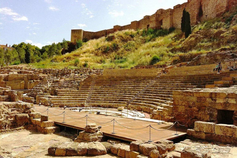 The Roman Theatre from Calle Alcazabilla, with the Alcazaba rising behind it