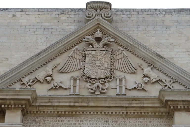 Habsburg eagle and carved pediment above Porta Napoli.