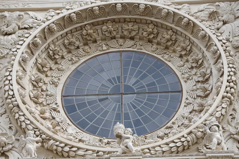 Carved rose window and stone ornament on the facade of the Basilica di Santa Croce.