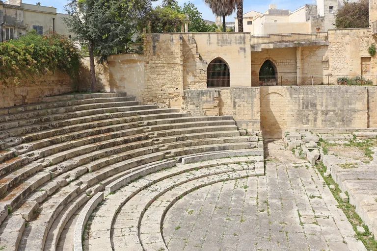 Semicircular stone seating and orchestra floor of Lecce's Roman Theatre.