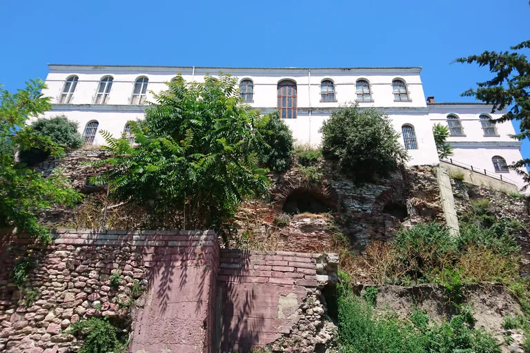 The substructure of the racetrack's curved southern end, with a nineteenth-century school standing on top of it