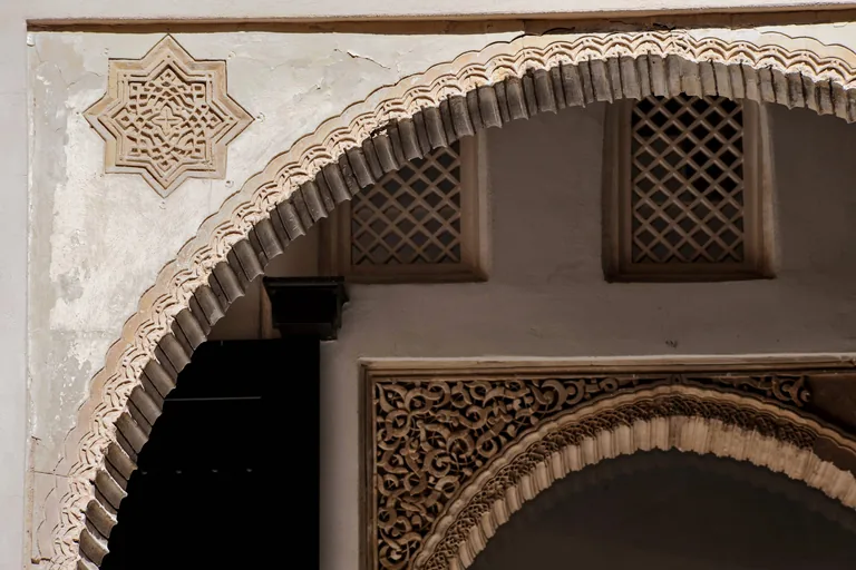 Nasrid arch and lattice windows in the courtyard