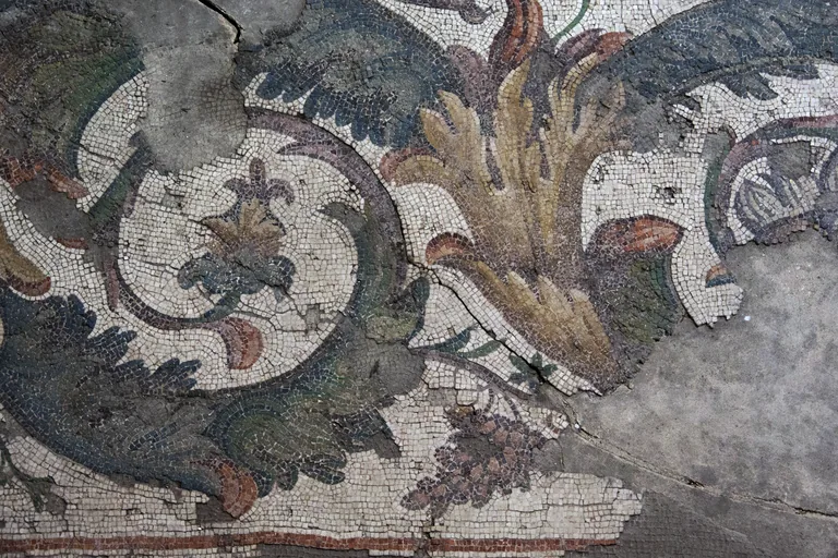 The peopled scroll that runs around the mosaic — the border the dating argument is now made from