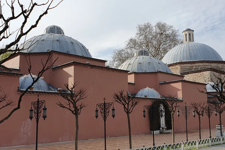 The long low building between the two great mosques, its two halves end to end under a row of lead domes