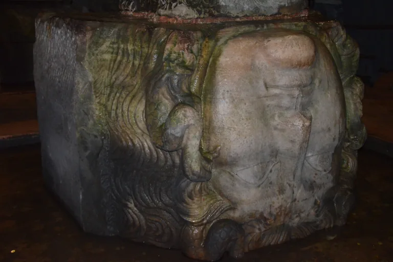 One of the two Roman heads used as a column base in the cistern, set on its side